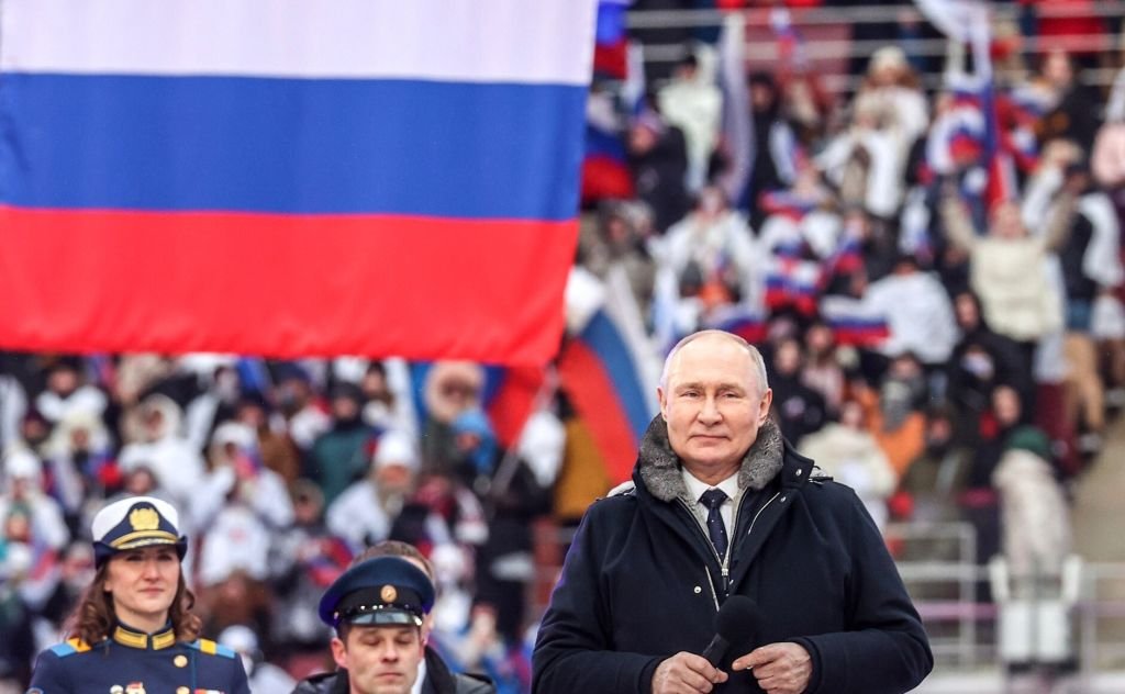 Владимир Путин во время митинга-концерта в Лужниках, 22 февраля 2023 года. Фото: Kremlin Press Office / Handout/Anadolu Agency / Getty Images
