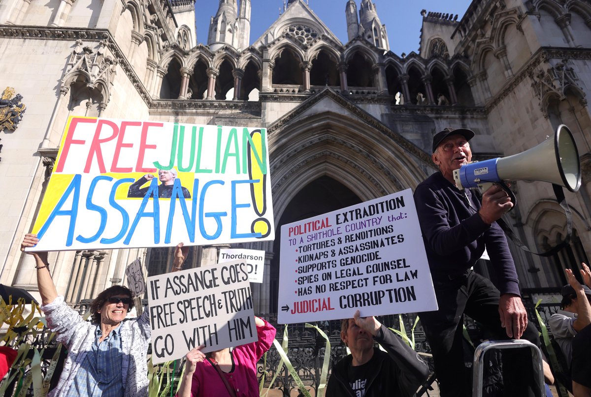 Сторонники Ассанжа держат плакаты у здания Высокого суда во время слушаний по апелляции на экстрадицию основателя WikiLeaks в Лондоне, Великобритания, 20 мая 2024 года. Фото: Neil Hall / EPA-EFE