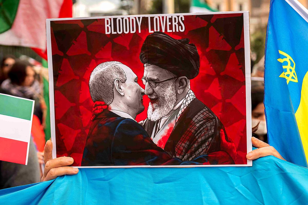 A sign with photo of the Supreme Leader of Iran Ali Khamenei and President of Russia Vladimir Putin during the demonstration in support of the Iranian community in the "Woman, Life, Freedom". Photo: Stefano Montesi — Corbis/Corbis via Getty Images