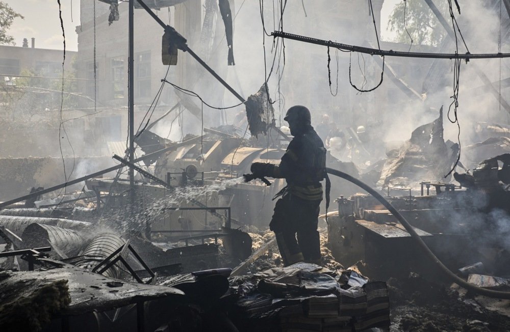 Ukrainian rescuers work at a printing house struck by a missile in Kharkiv on 23 May, with seven people killed and 16 others wounded in the attack Photo: EPA-EFE/SERGEY KOZLOV