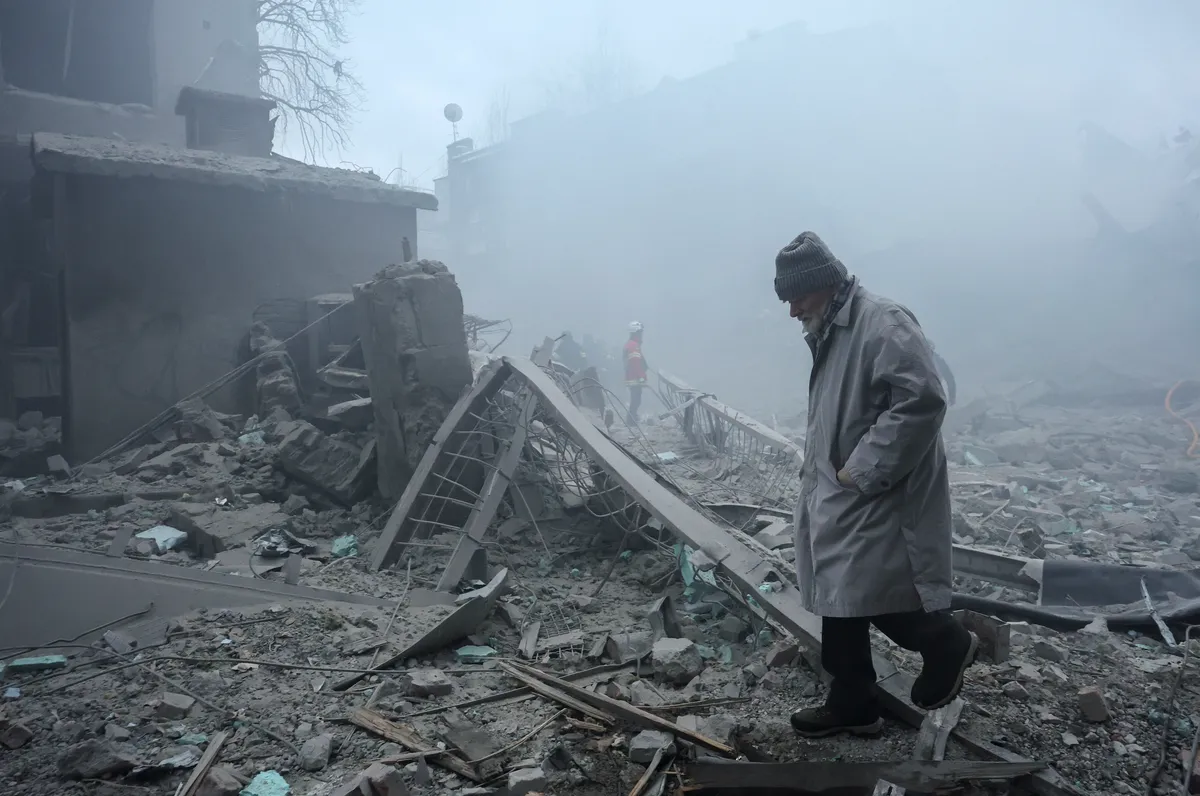 A man walks through the rubble after a Russian strike on a residential area in Kharkiv, northeastern Ukraine, 2 January 2026. Photo: EPA / Sergey Kozlov