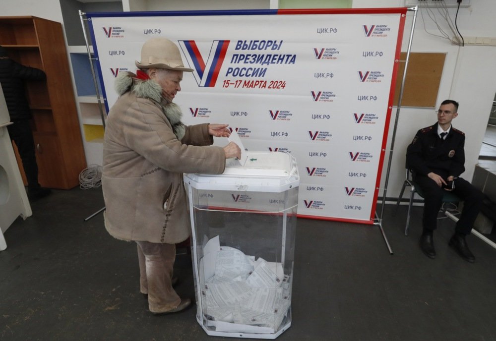 A woman casts her ballot during the presidential election in Moscow last Friday. Photo: EPA-EFE/MAXIM SHIPENKOV