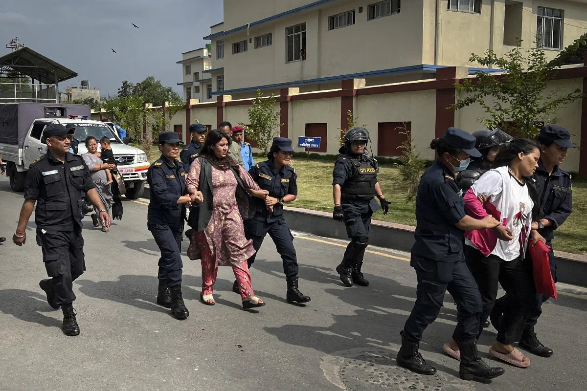 Police escort Deepa Singh Shahi (front) and Kritu Bhandari (centre) away from the Ministry of Foreign Affairs. Photo: Irina Kravtsova / Novaya Gazeta Europe