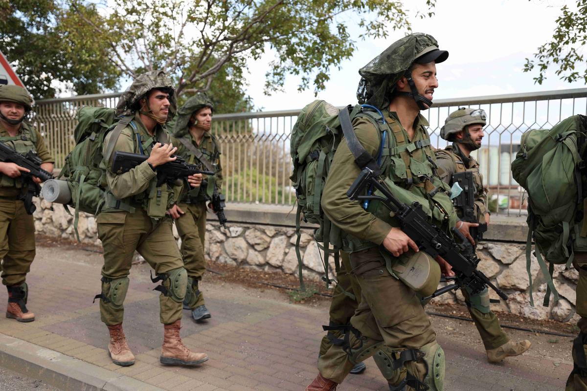 Вооруженные израильские солдаты патрулируют улицу в Кирьят-Шмоне, север Израиля. Фото: EPA-EFE / ATEF SAFADI