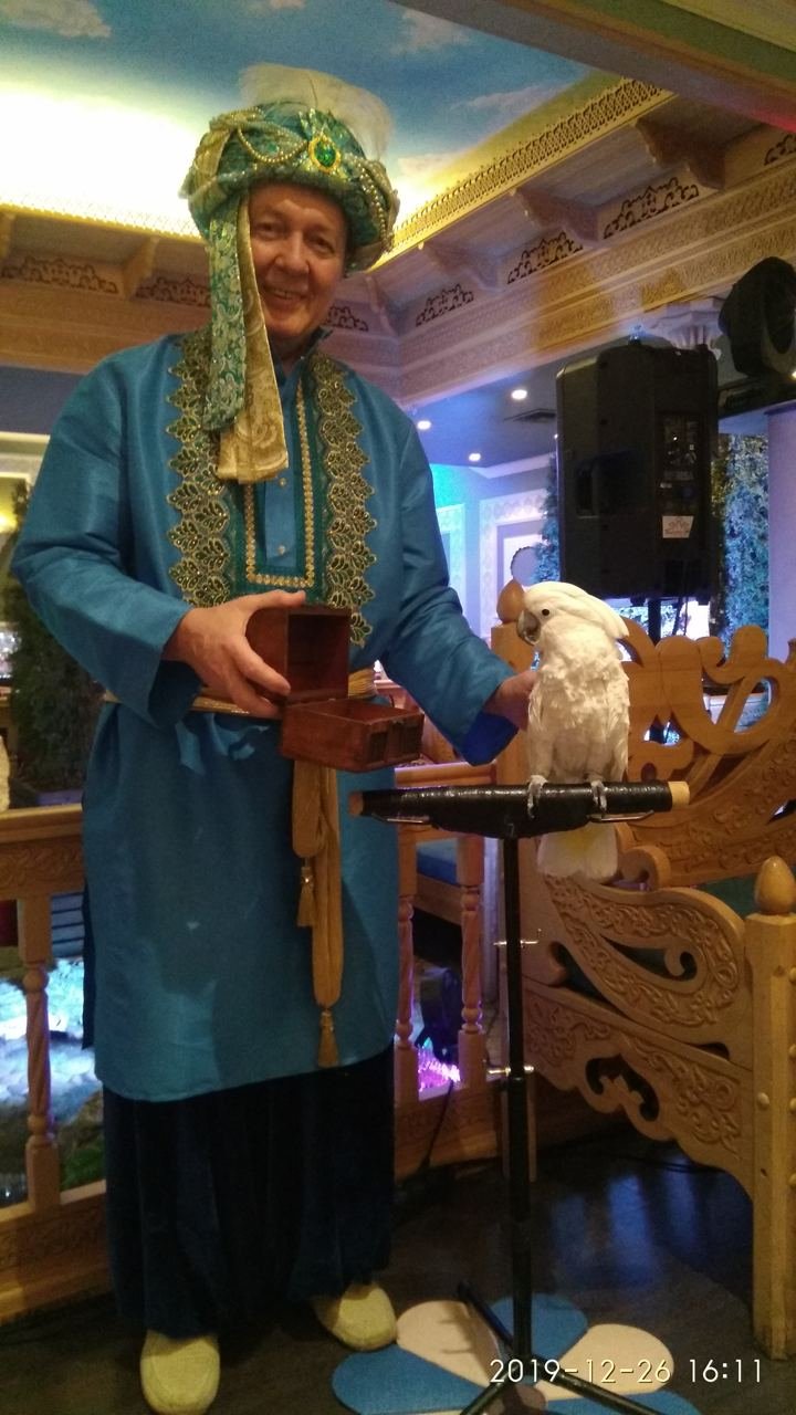 Mikhail Zhukov in a welcome zone with a fortune-telling parrot before a performance. Moscow, 2019. Photo contributed by Alexander Zhukov