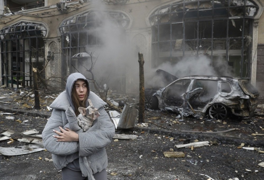 A woman and her dog in the aftermath of a Russian missile strike on Kyiv, Ukraine, 20 December 2024. Photo: EPA-EFE / SERGEY DOLZHENKO