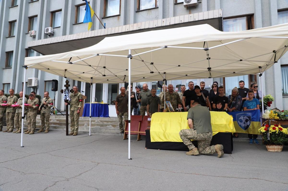 A soldier at the coffin of UAF pilot Oleksiy Mes, 29 August 2024. Photo:  Ukrainian Air Force