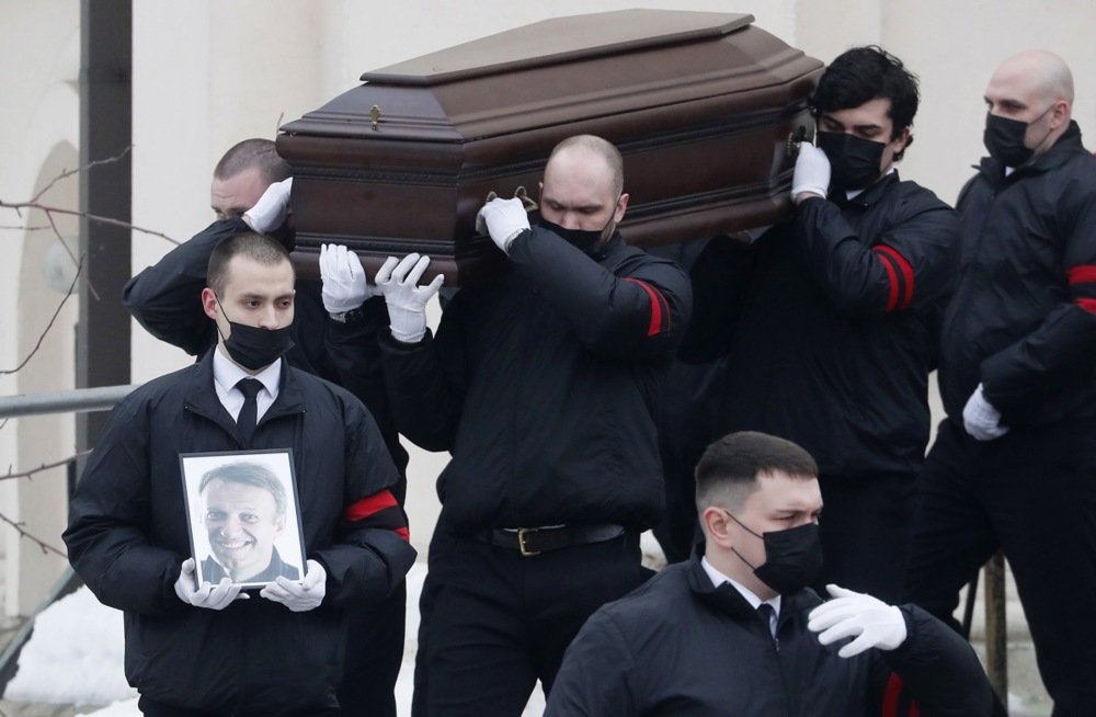 Funeral service workers carry the coffin of late Russian opposition leader Alexey Navalny during his funeral in Moscow, Russia, 1 March. Photo. EPA-EFE/SERGEI ILNITSKY