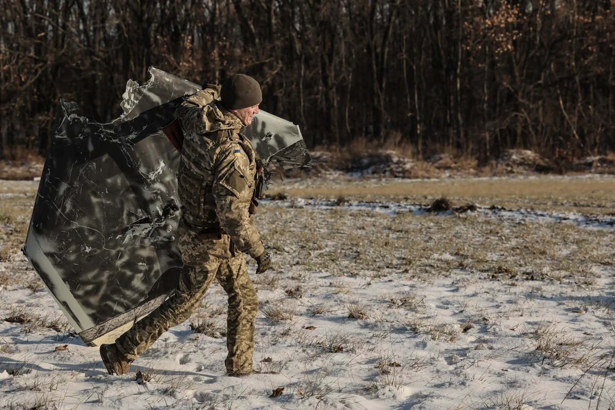 A Ukrainian soldier carrying the debris of a Shahed drone near Kyiv. Photo: Oleg Petrasiuk / EPA-EFE