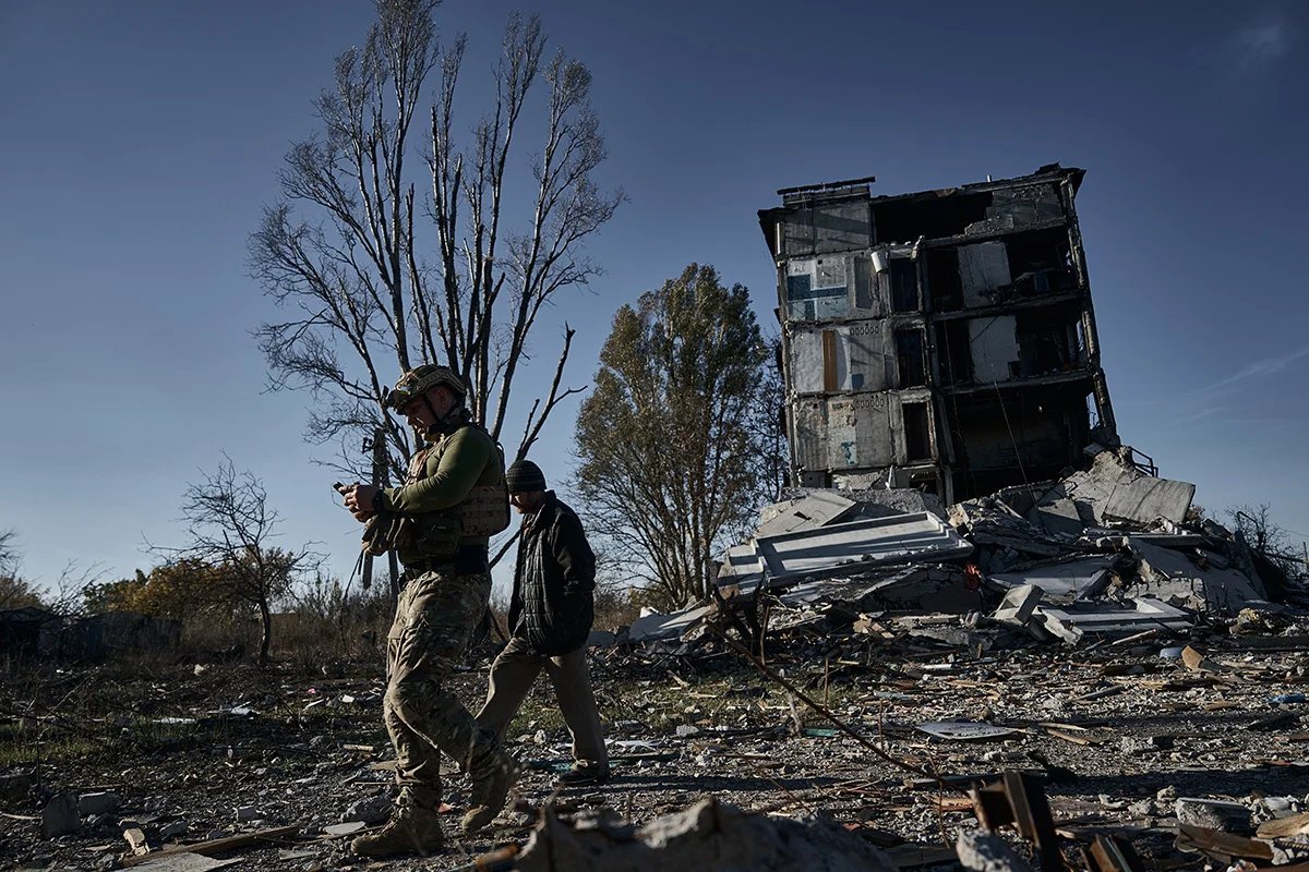 A police officer escorting a local man as he evacuates from Avdiivka, October 2023. Photo: Vlada Liberova / Libkos / Getty Images