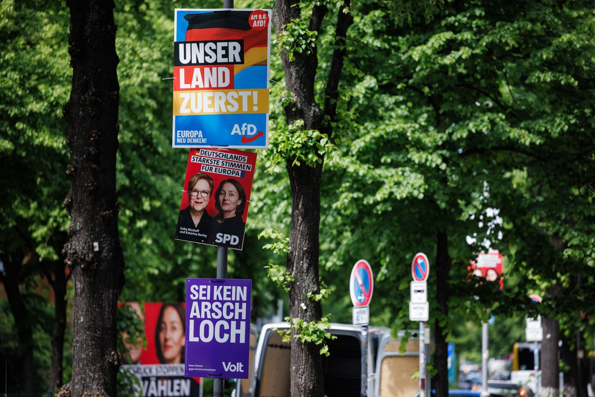 Агитационные плакаты «Альтернативы для Германии» — «Наша страна прежде всего», социал-демократической партии — «Сильнейшие голоса Германии для Европы» и партии «Вольт» — «Не будь засранцем», Берлин, Германия, 6 мая 2024 г. Фото: Clemens Bilan / EPA-EFE