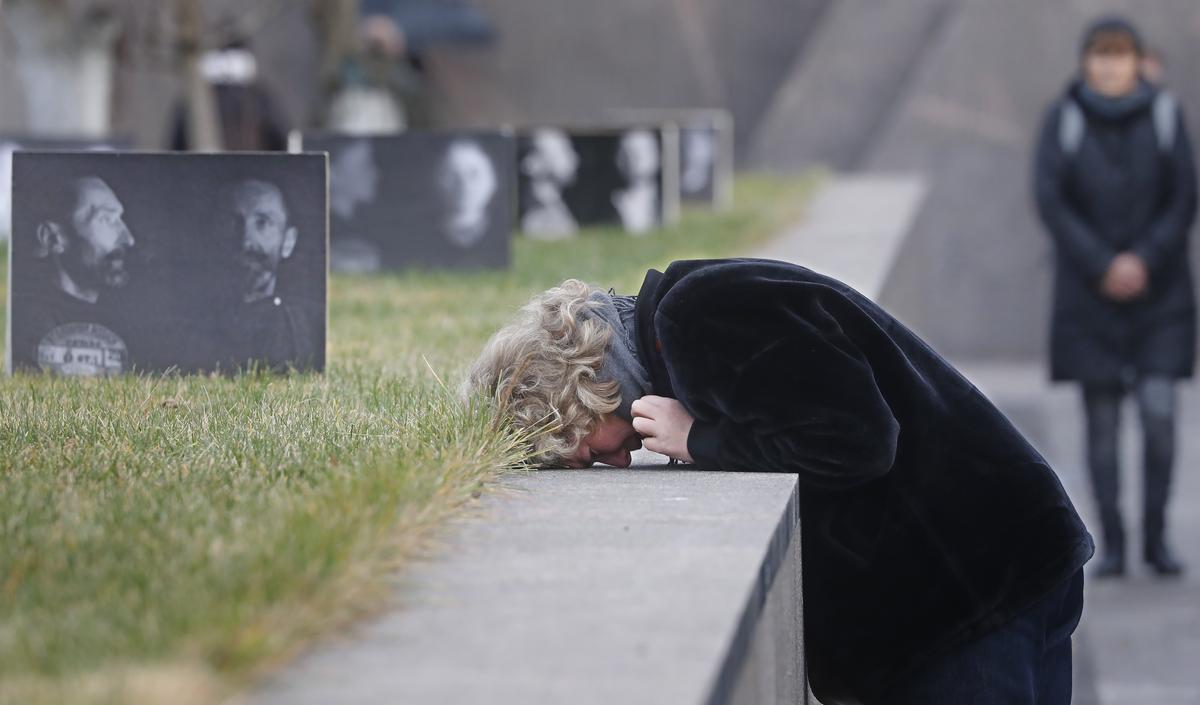 Visitors to the memorial walls at the Butovo Firing Range outside Moscow, where some 20,762 people were executed during Stalin’s Great Terror in 1937-1938. Photo: EPA-EFE / MAXIM SHIPENKOV