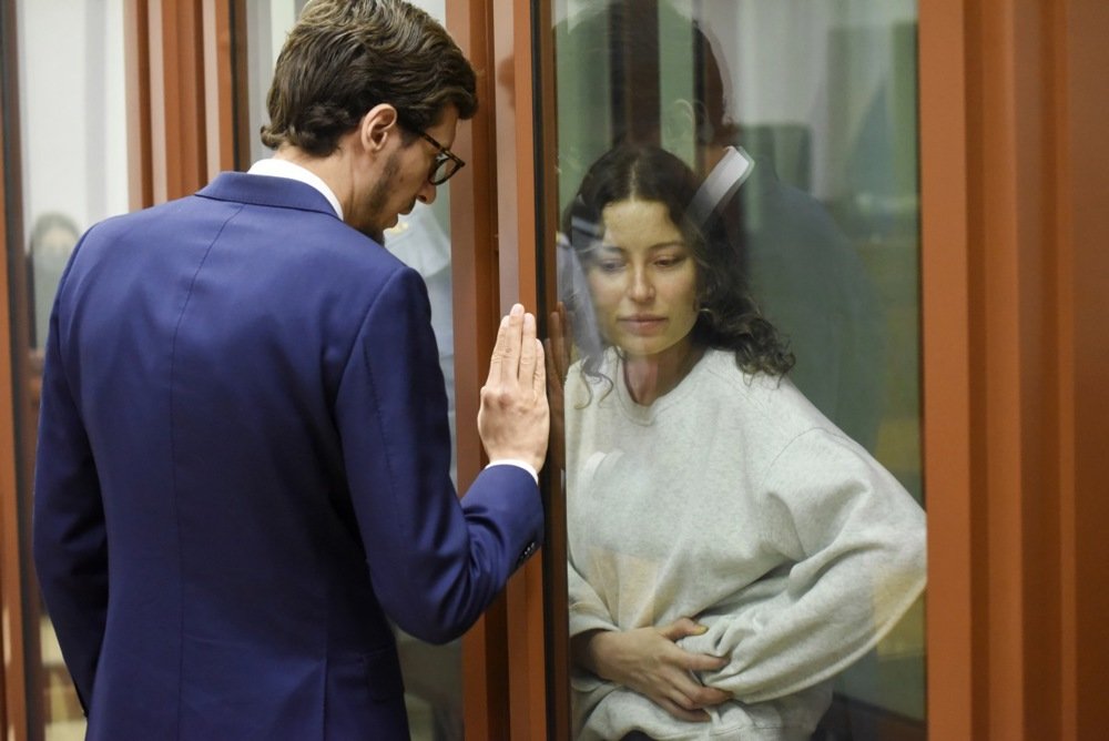 Ksenia Karelina speaks with her lawyer during her August court hearing. Photo: EPA-EFE/STRINGER