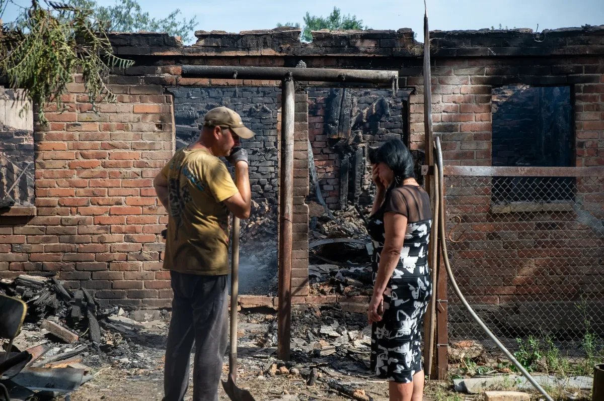 Residents of Ukraine’s Bakhmut in front of the ruins of their house, August 2022. Photo: Madeleine Kelly / SOPA Images / LightRocket / Getty Images