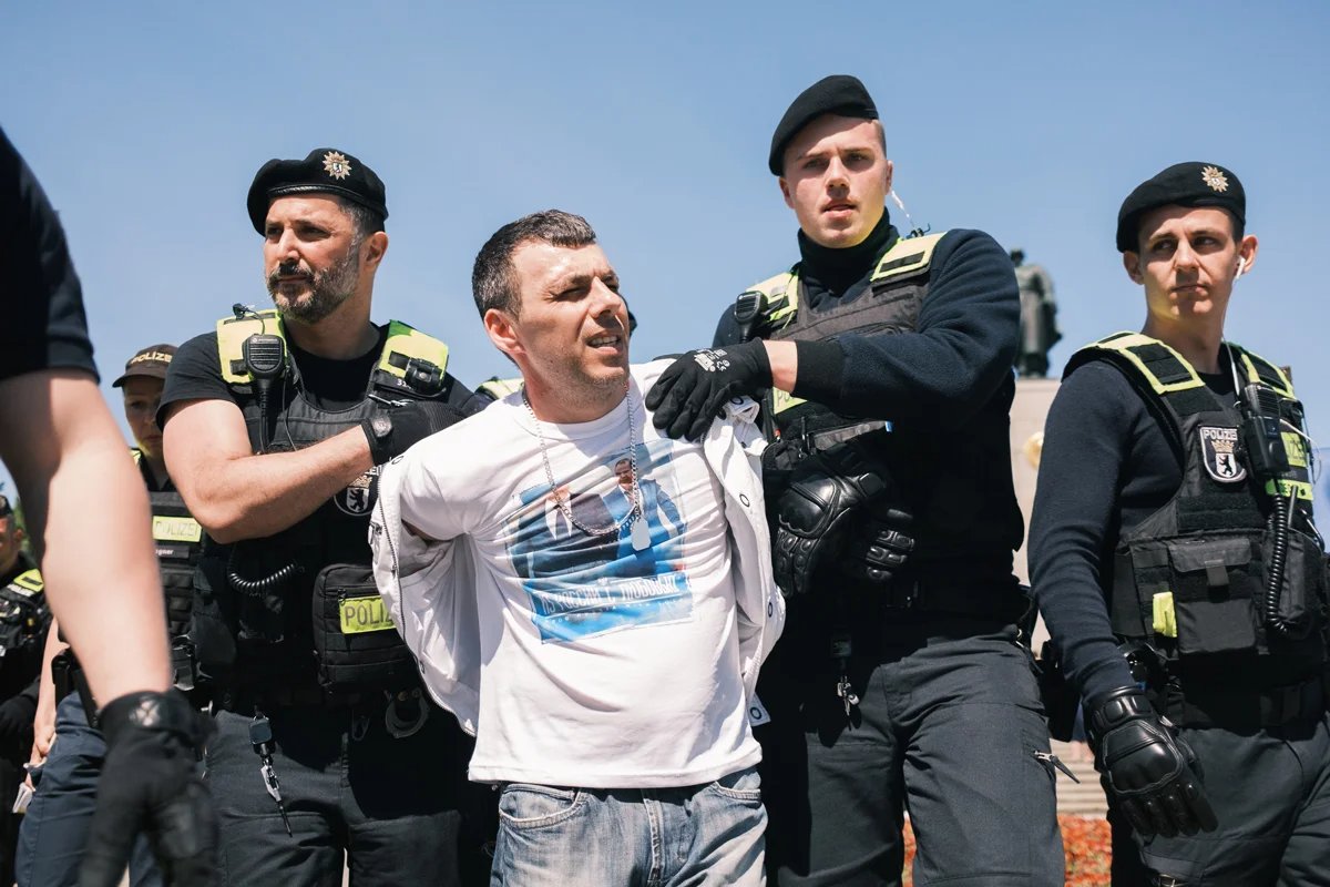 A man is detained by police for attempting to snatch a Ukrainian flag from a bystander. Photo: Daniil Mashtakov