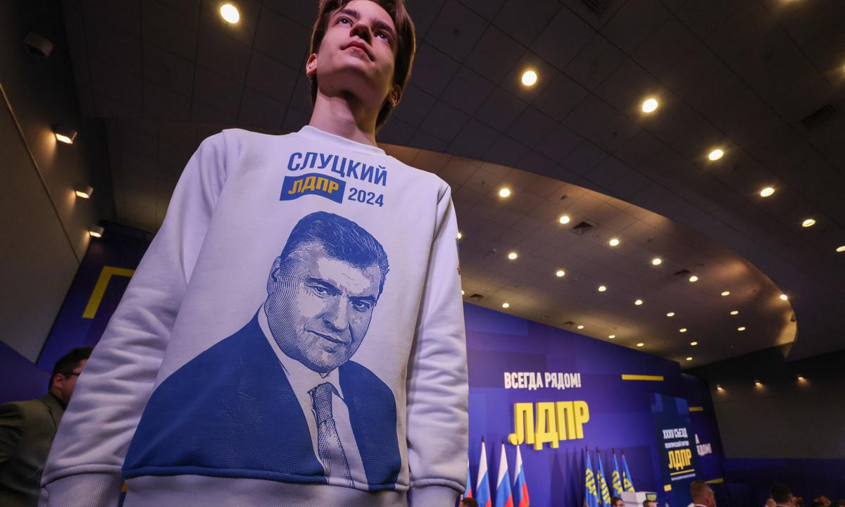 A volunteer shows his support for Slutsky during the party’s pre-election congress. Photo: EPA-EFE / SERGEI ILNITSKY