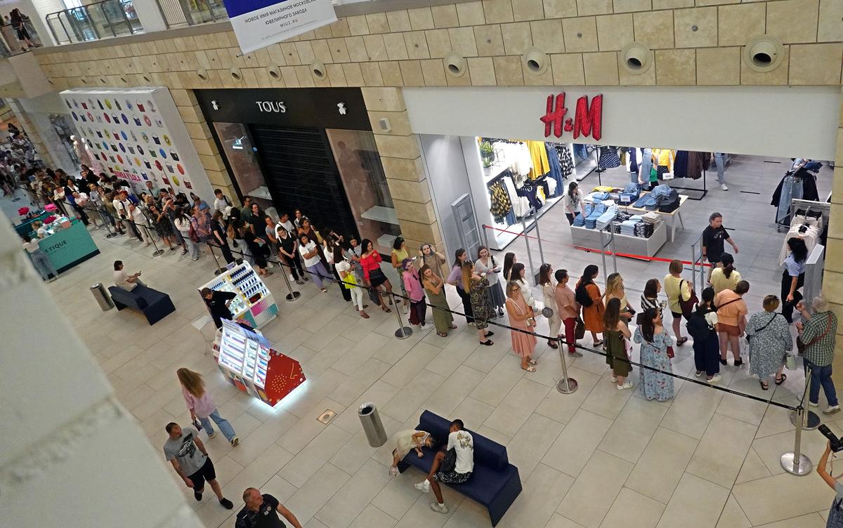 Russian people stand in line to enter H&M store in the Metropolis shopping mall in Moscow, Russia, 03 August 2022. Photo by EPA-EFE/MAXIM SHIPENKOV