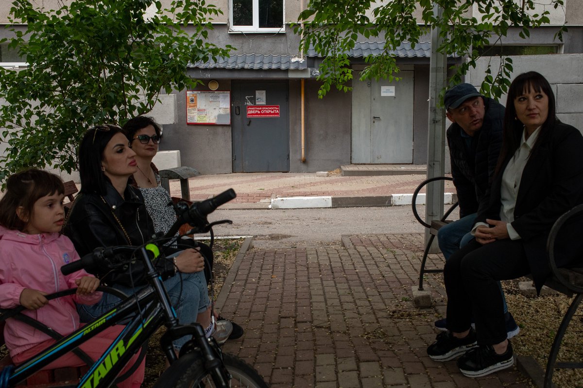 Белгородцы на фоне подъезда, в котором можно укрыться во время обстрела, 9 мая 2024 года. Фото: Александр Каратаев / «Новая газета Европа»