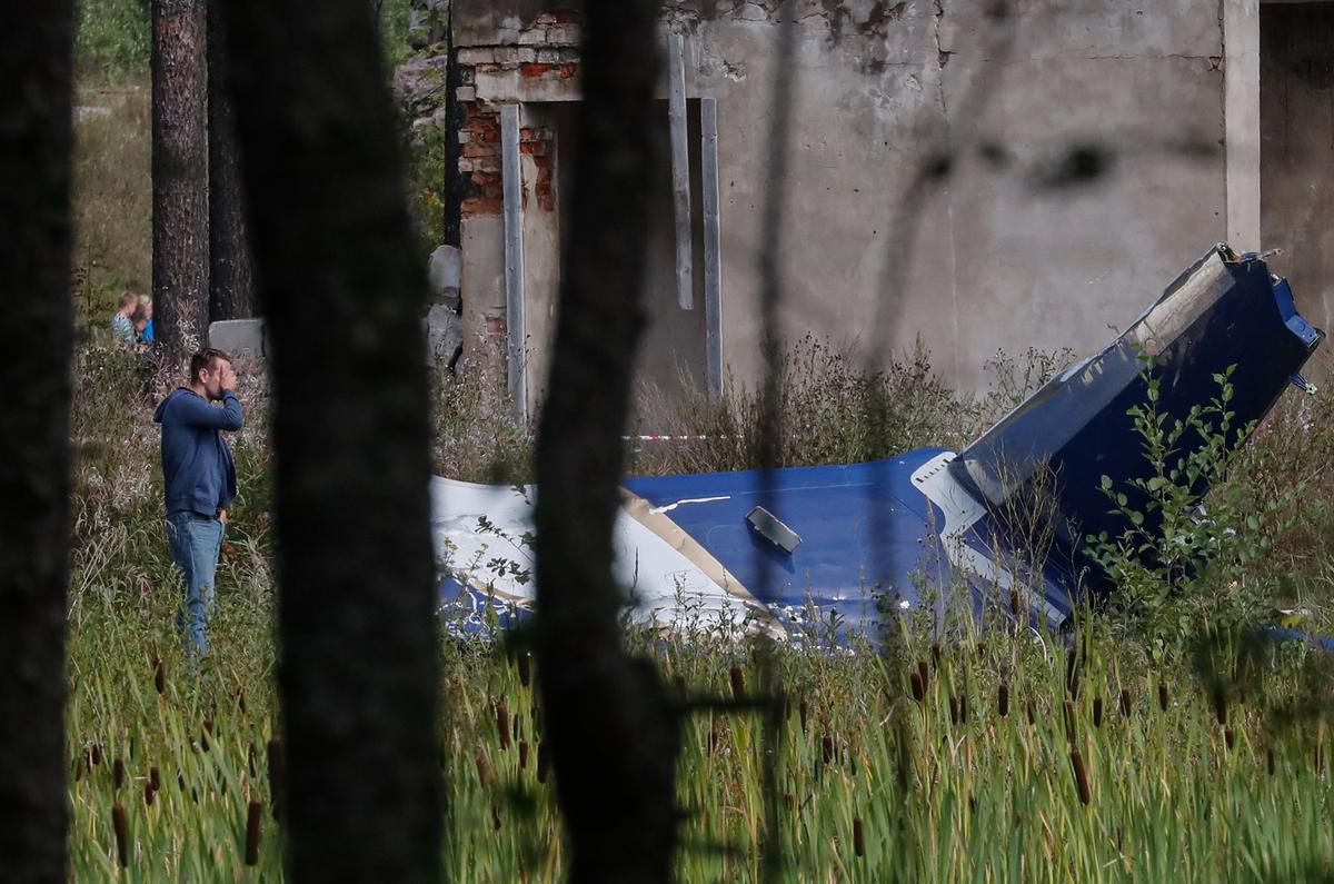 A man looks at the wreckage of the plane that was carrying Yevgeny Prigozhin near the village of Kuzhenkino, in the Tver region, on 24 August 2023. Photo: EPA-EFE / ANATOLY MALTSEV