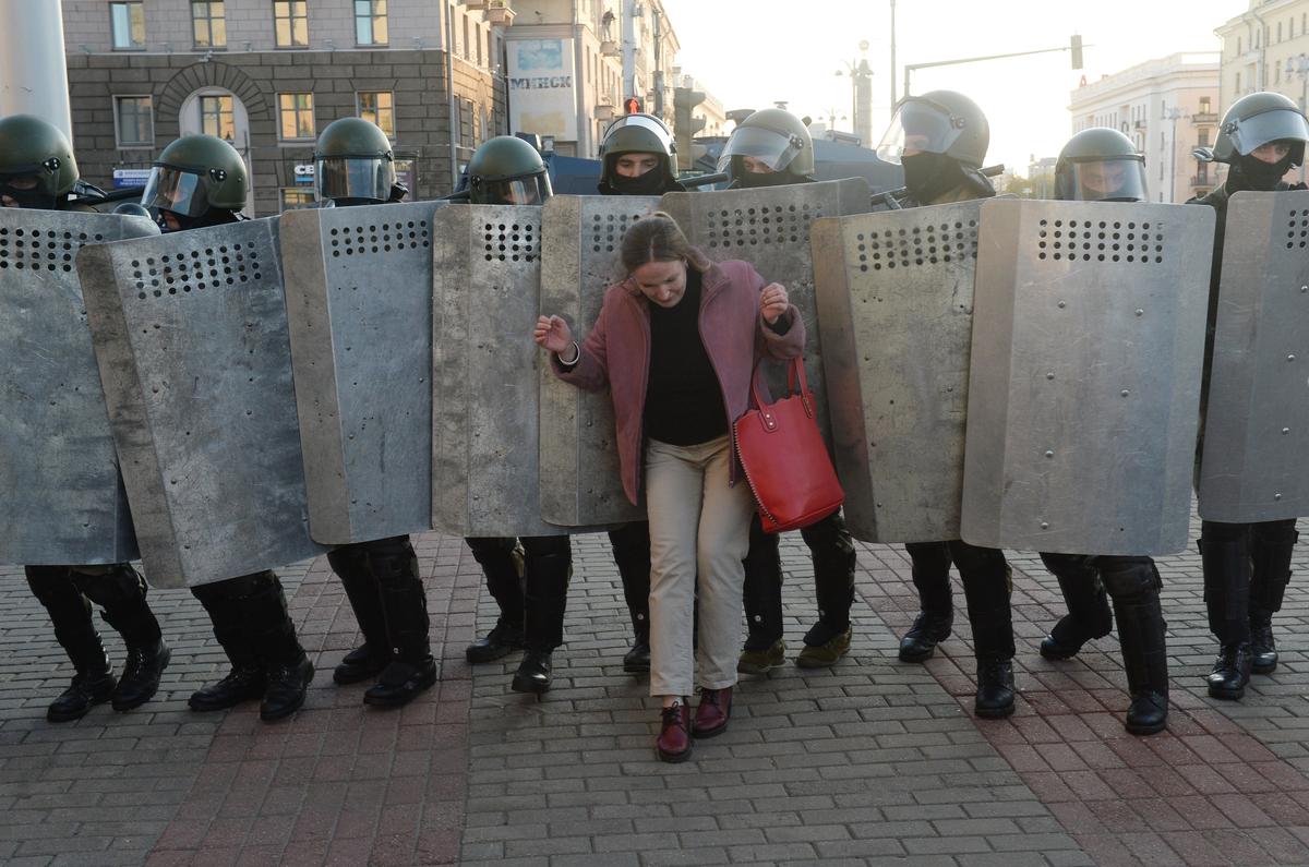 Riot police surround a protester during a rally against the presidential election results in Minsk, Belarus, 20 September 2020. Photo: EPA