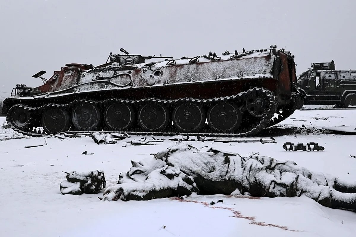 A soldier’s body lies next to a burnt out Russian armoured personnel carrier near Kharkiv, Ukraine, February 2022. Photo: Sergey Kozlov / EPA-EFE