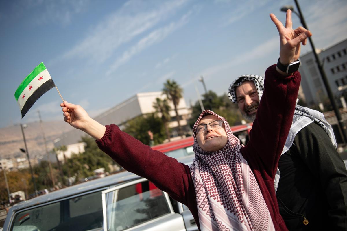 People celebrate as rebels capture the Syrian capital Damascus, 8 December 2024. Photo: EPA-EFE / HASAN BELAL