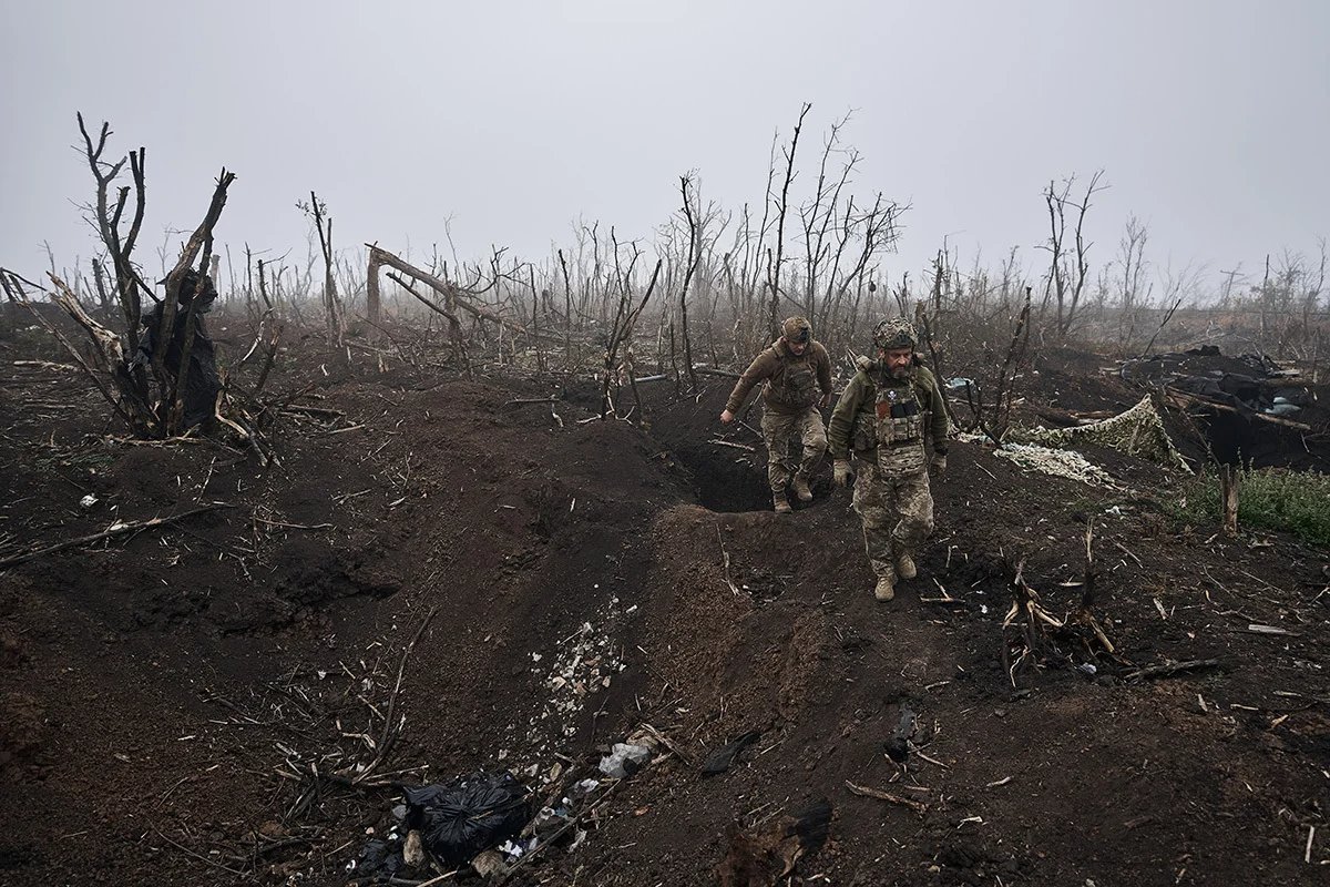 Ukrainian soldiers heading through a destroyed landscape in the morning fog near Bakhmut in October. Photo: Kostya Liberov / Libkos / Getty Images