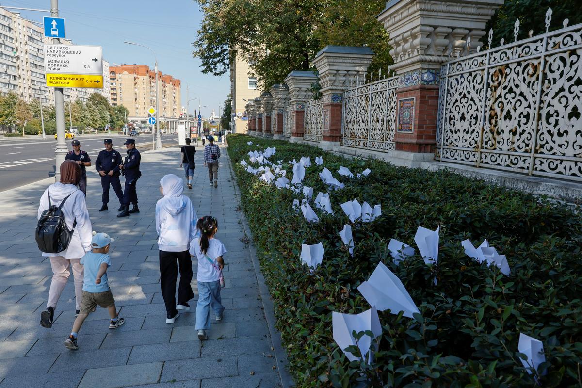 Прохожие на фоне бумажных самолетиков возле посольства Франции в Москве после задержания Павла Дурова, 25 августа 2024 года. Фото: Юлия Морозова / Reuters / Scanpix / LETA