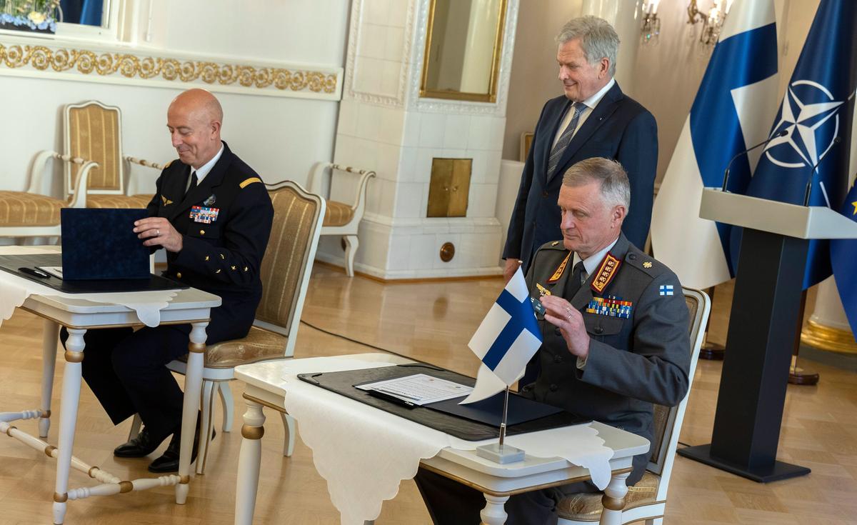 Finland’s President Sauli Niinisto (C) looks on as Commander of the Finnish Defenсe Forces, General Timo Kivinen (R) and NATO's Supreme Allied Commander Transformation General Philippe Lavigne (L) sign a joint statement on concluding the military accession process of Finland's NATO membership, at the Presidential Palace in Helsinki, Finland, 12 June 2023. Photo by EPA-EFE/Mauri Ratilainen