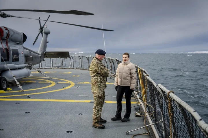 Danish Prime Minister Mette Frederiksen (R) talks with the chief of the Arctic Command, Soeren Andersen, on a Danish Navy vessel near Nuuk, Greenland, 3 April 2025. Photo: EPA /Mads Claus Rasmussen
