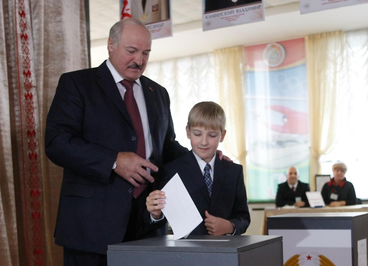 Lukashenko lets his youngest son Nikolay cast his ballot for him at a polling station in Minsk during parliamentary elections in Belarus on 23 September 2012. Photo: EPA / TATYANA ZENKOVICH