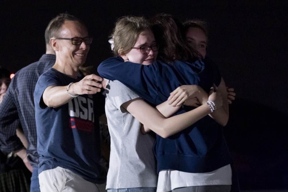 Alsu Kurmasheva hugs her husband and daughters following her arrival at Andrews Air Base in Maryland, 1 August 2024. Photo: EPA-EFE/ Ken Cedeno / POOL