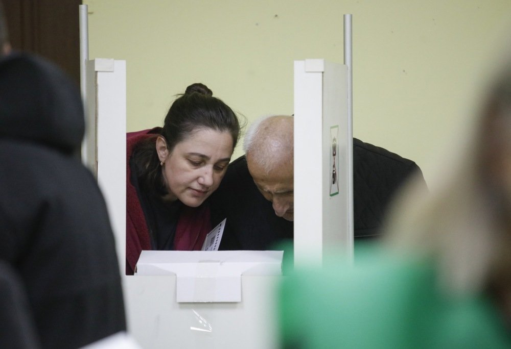 Georgians cast their ballots at a polling station in Tbilisi on Saturday. Photo: EPA-EFE/DAVID MDZINARISHVILI