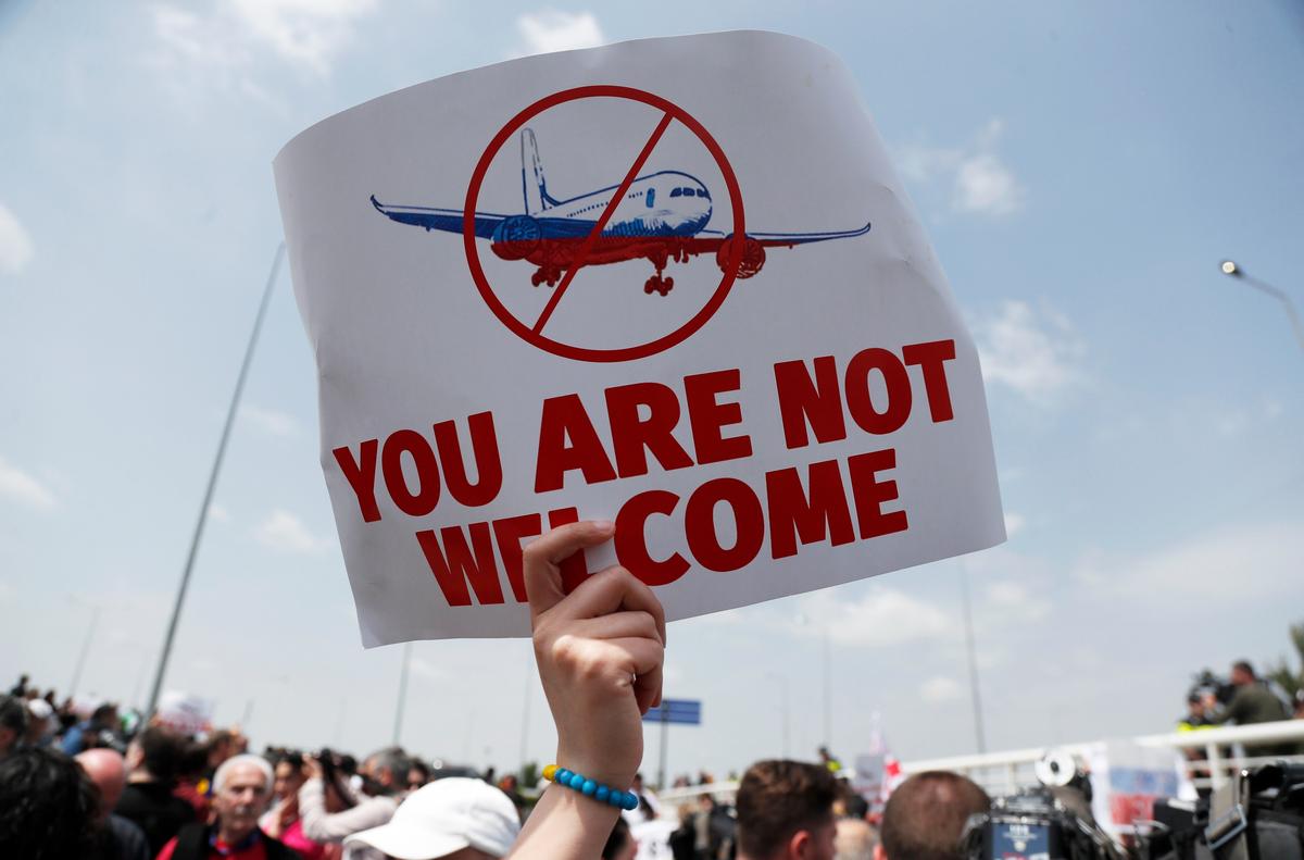 Люди протестуют против возобновления авиасообщения с Россией во время прибытия первого прямого рейса из Москвы в Тбилисский международный аэропорт в Тбилиси, Грузия, 19 мая 2023 года. Фото: Зураб Курцикидзе / EPA-EFE