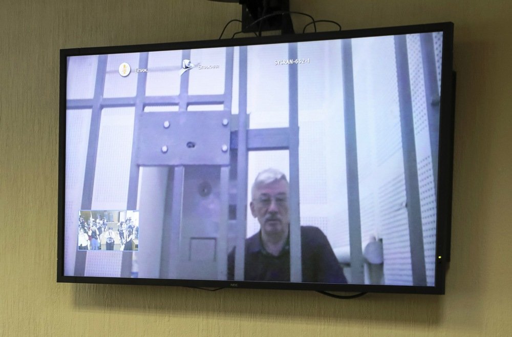 Oleg Orlov is seen on TV screen as he participates in a court appeal hearing via video link from his prison against his sentence at the Moscow City Court in Moscow, Russia, 11 July 2024. Photo: EPA-EFE/MAXIM SHIPENKOV